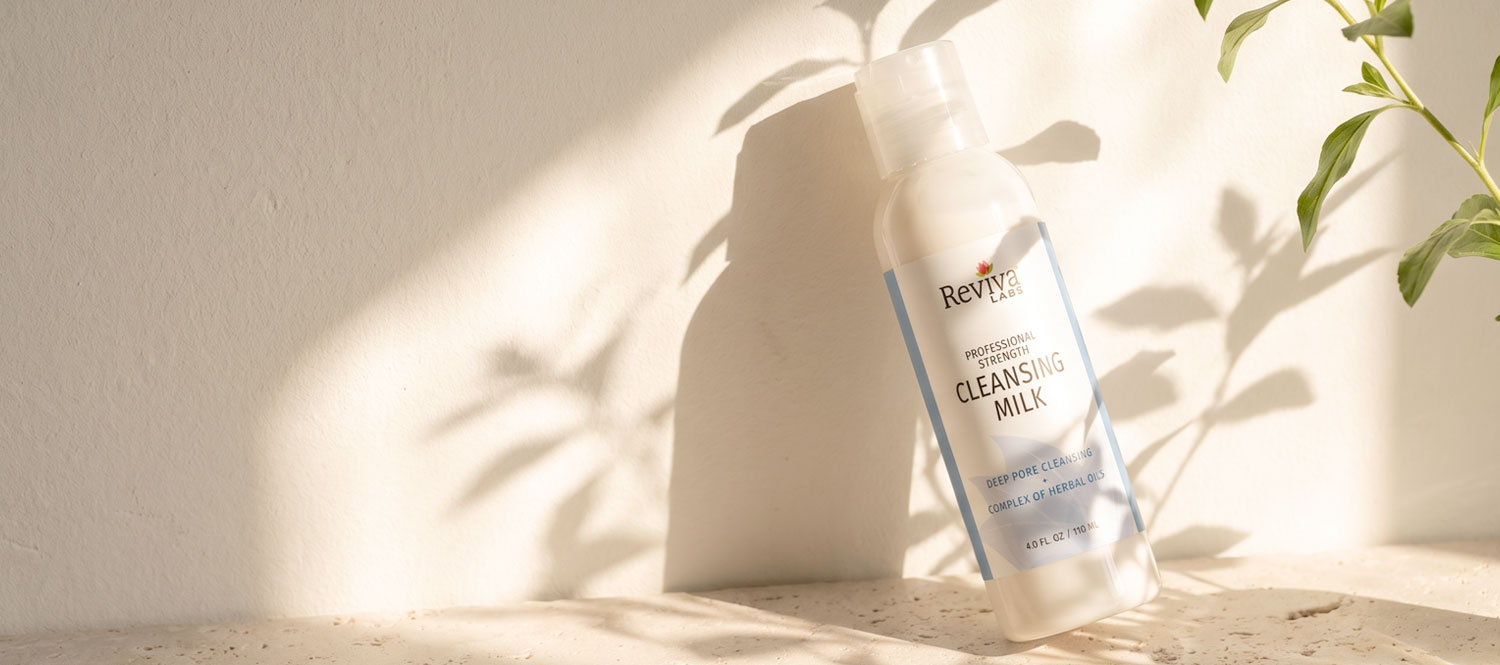 Reviva Labs cleansing milk bottle in sunlit setting