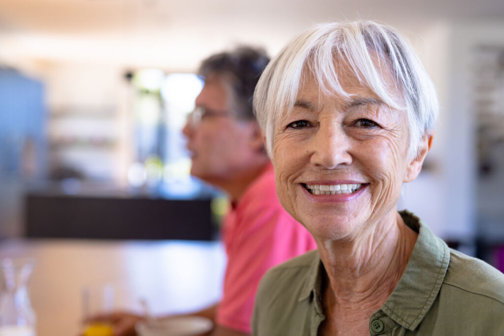 Smiling older woman with short gray hair indoors