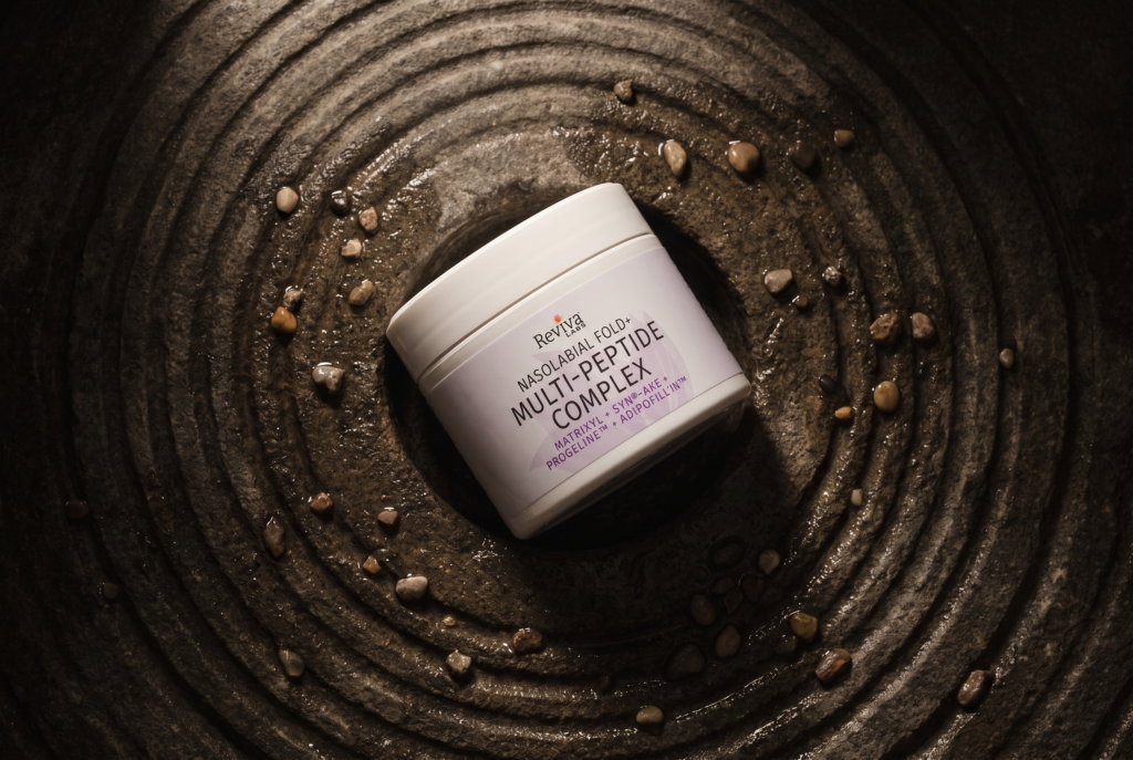 Multi-peptide face cream jar on textured surface