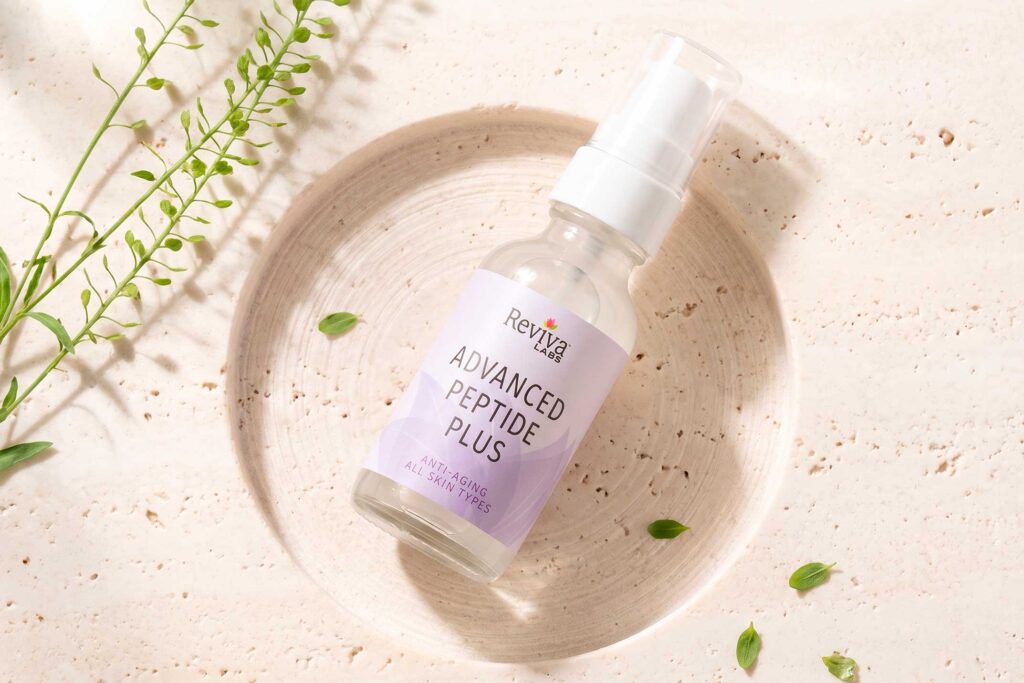 Reviva Labs Advanced Peptide Plus serum bottle with greenery