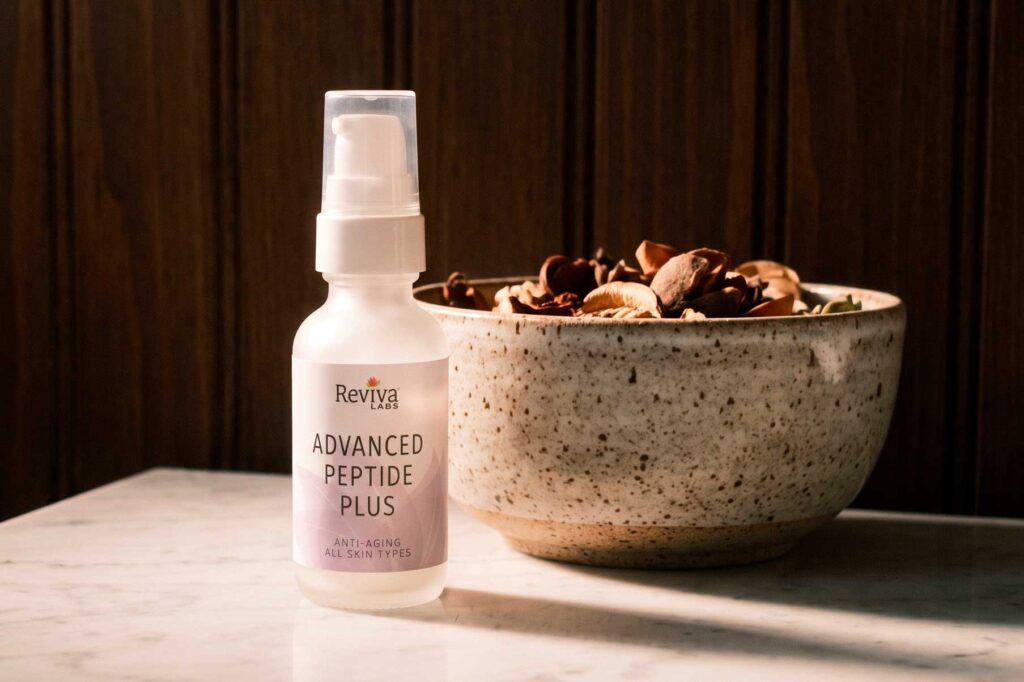 Reviva Labs Advanced Peptide Plus serum bottle beside decorative bowl