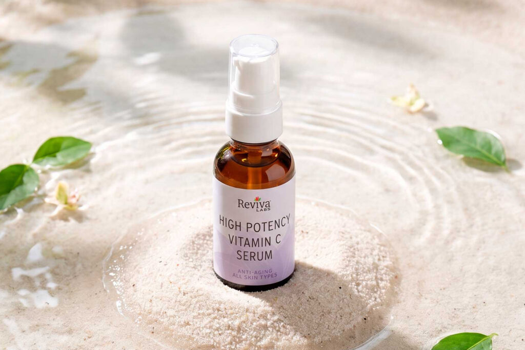 Reviva Labs vitamin C serum bottle on sand