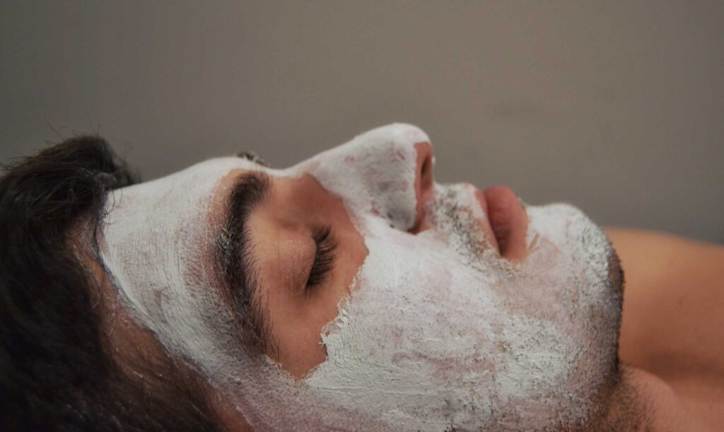 Woman relaxing with a white facial mask
