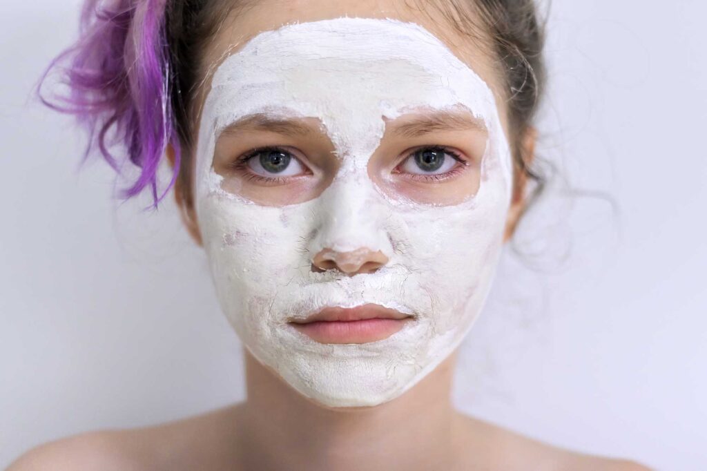 Woman wearing a white facial clay mask