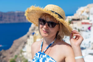 Woman in straw hat overlooking seaside cliffs
