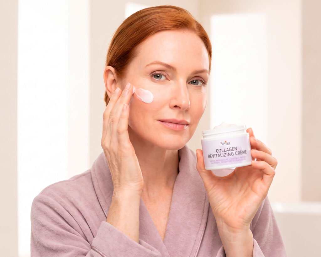 Woman applying collagen cream while holding Reviva Labs jar